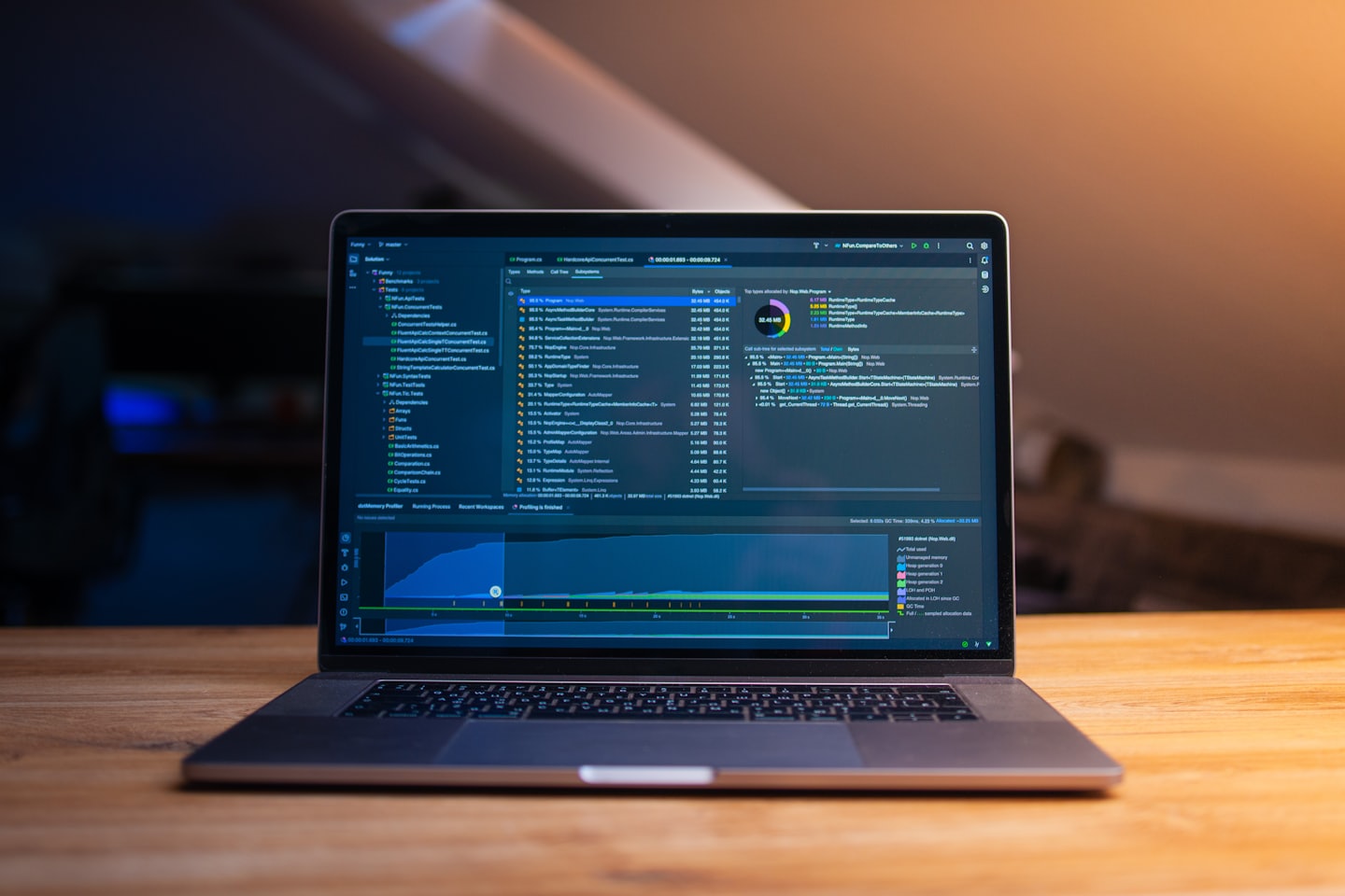 Open laptop displaying software code and data on a desk.